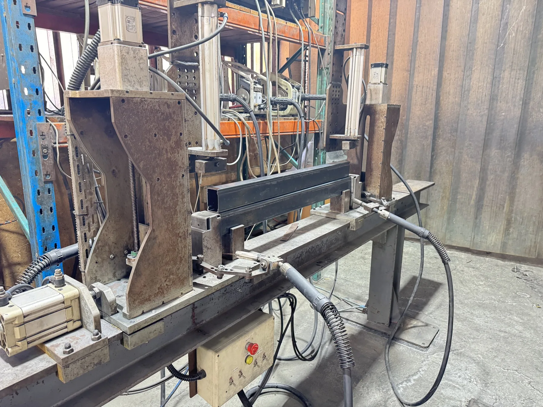 Pneumatic and servo welding fixture in an industrial workshop